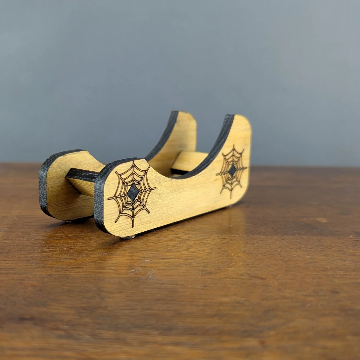 Side angle of Webworks Coaster Holder with engraved spiderweb designs