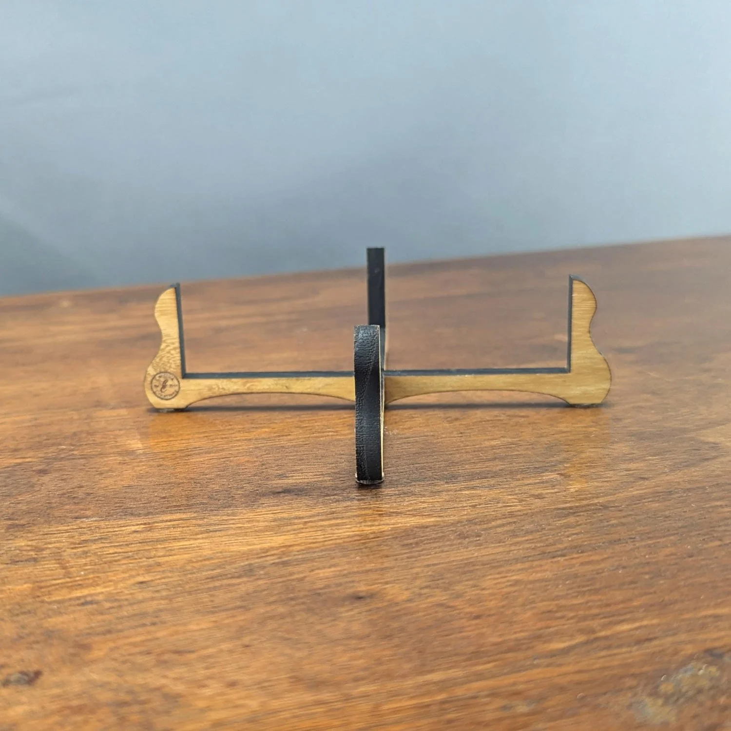 Black locust coaster holder on wood surface