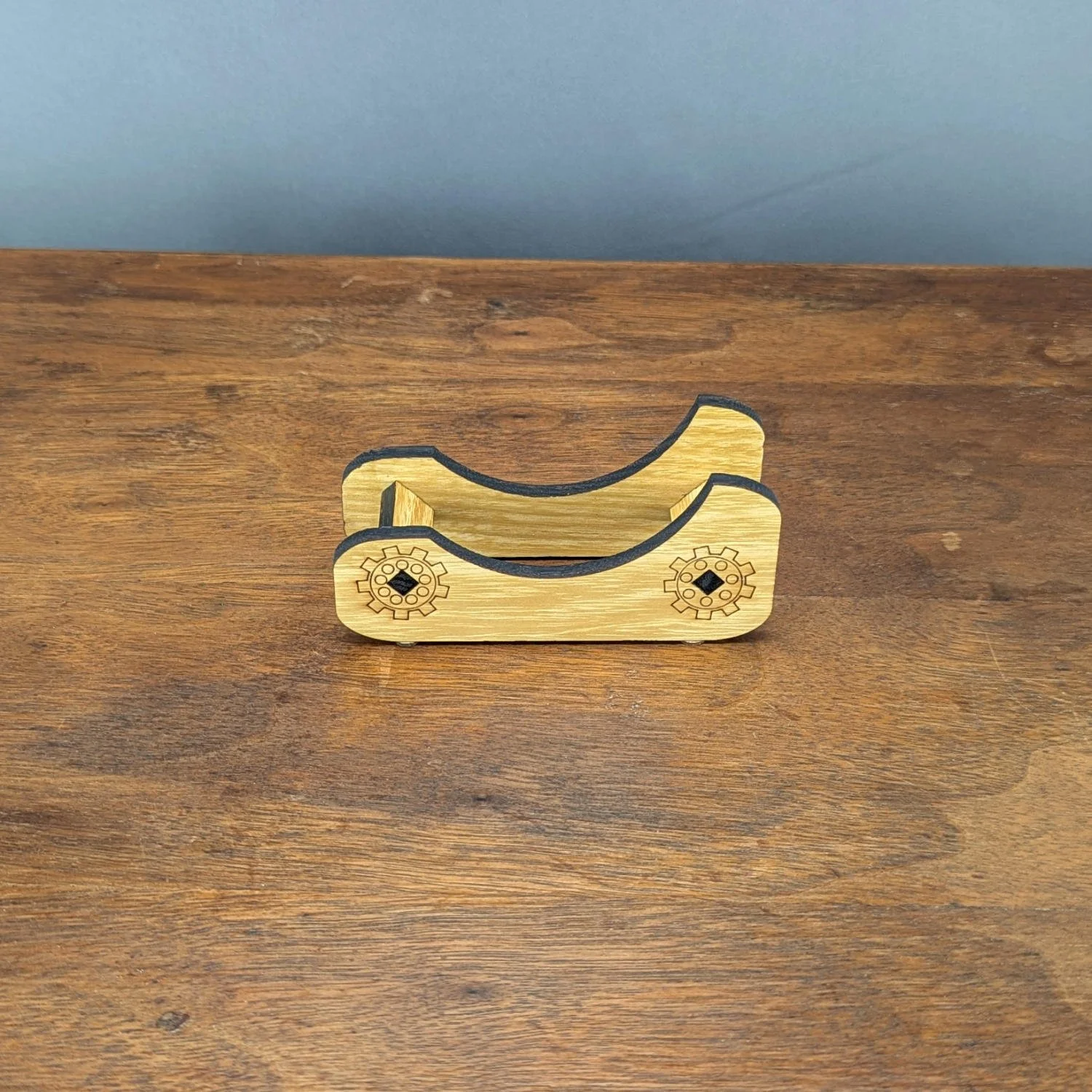 Laser-cut wooden coaster holder with gear engravings