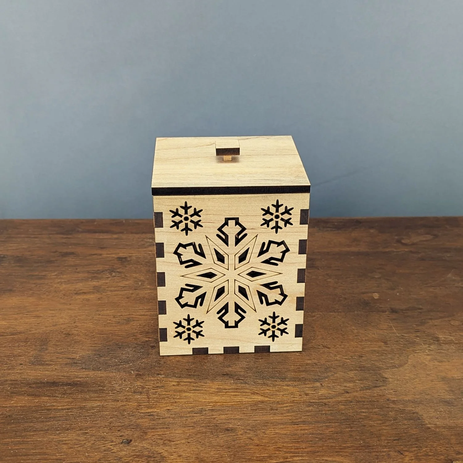Front view of the Maple Snowflake Lantern showing snowflake cutouts and maple grain.