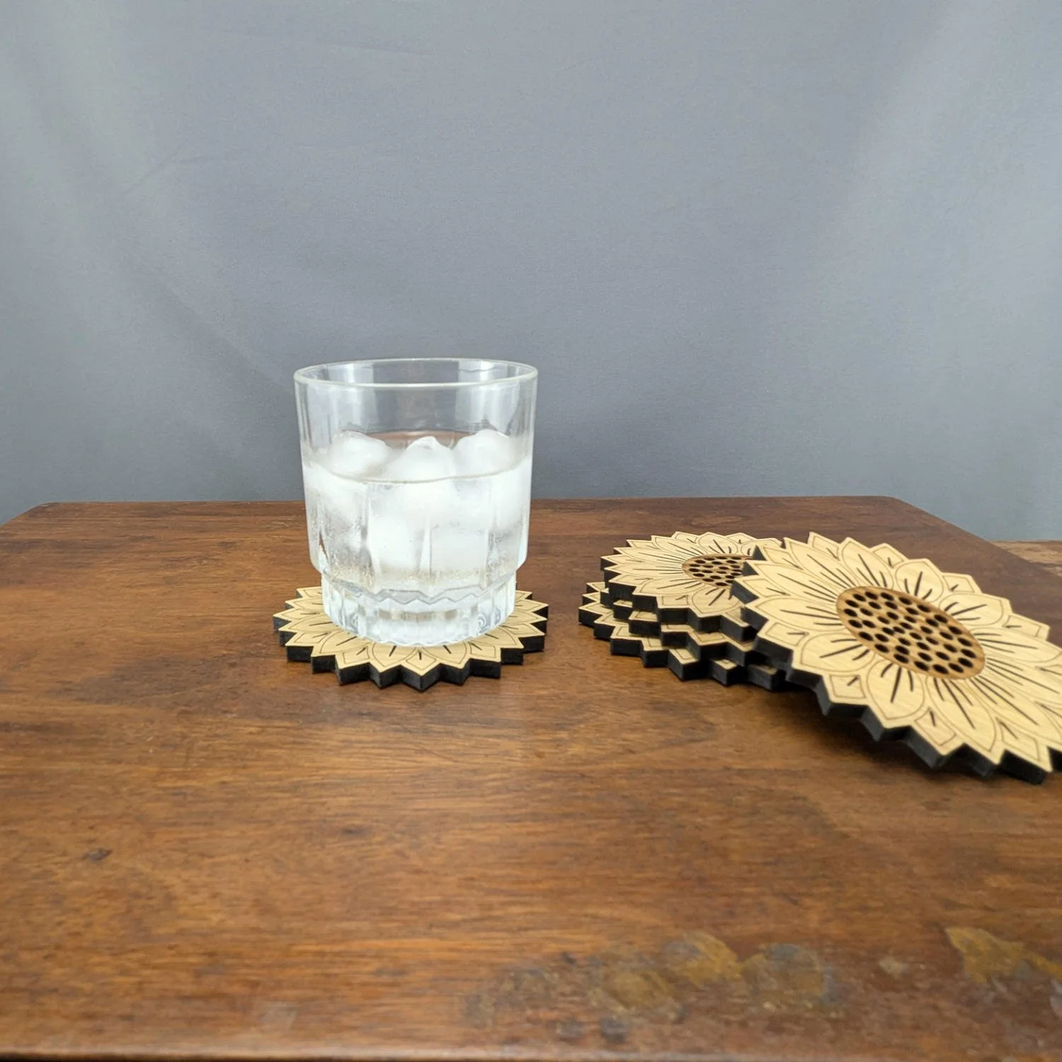 Table setting with sunflower coaster under glass