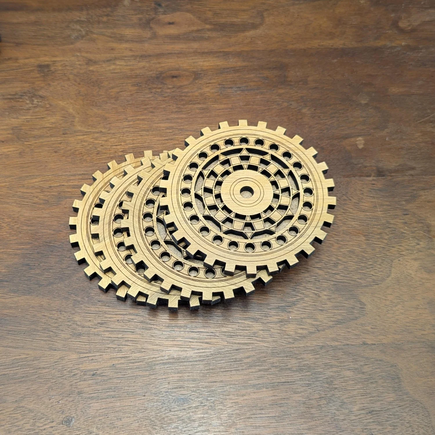 Stack of four Engineer wooden drink coasters featuring detailed gear-inspired design.