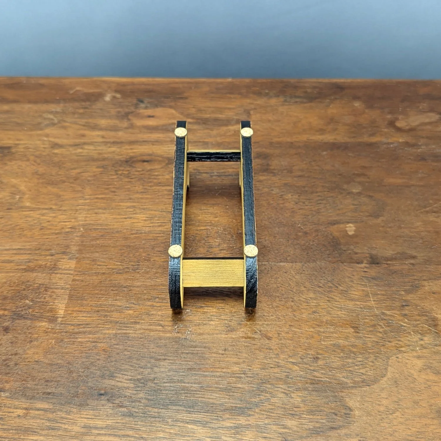 Top-down view of wooden Webworks Coaster Holder with cork feet visible