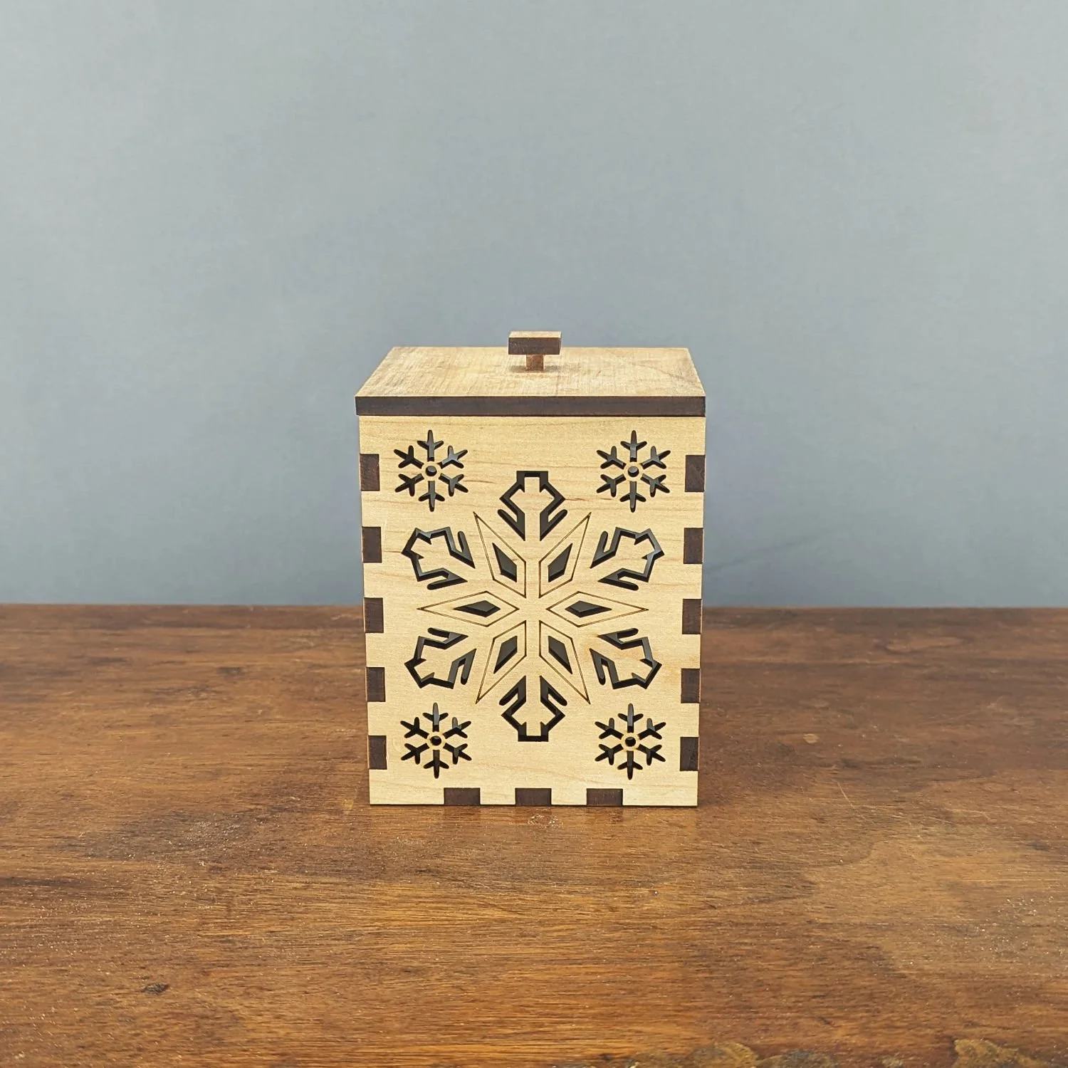 Front view of the Maple Snowflake Lantern highlighting solid maple grain and snowflake cutouts.