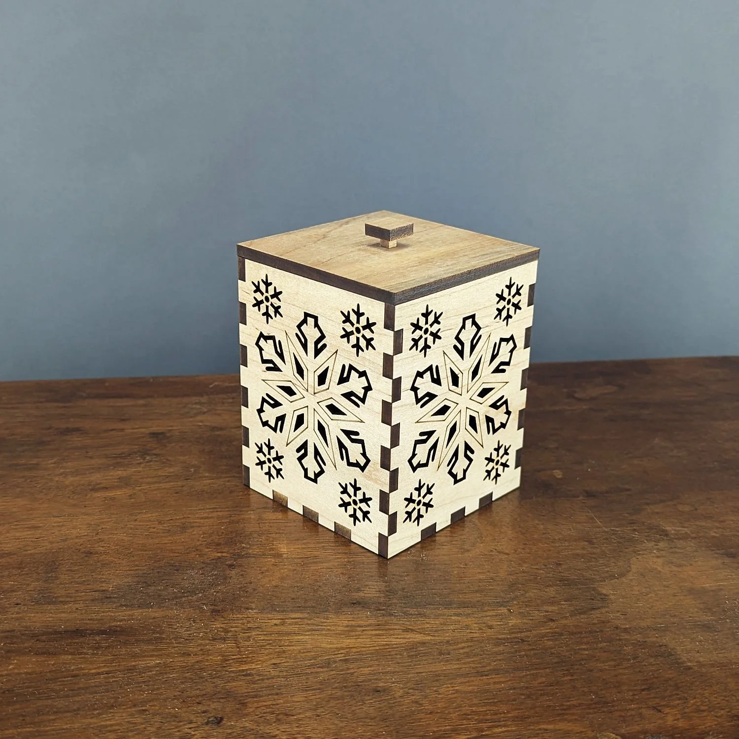 Angled view of the Maple Snowflake Lantern highlighting box-joint corners and cutouts.