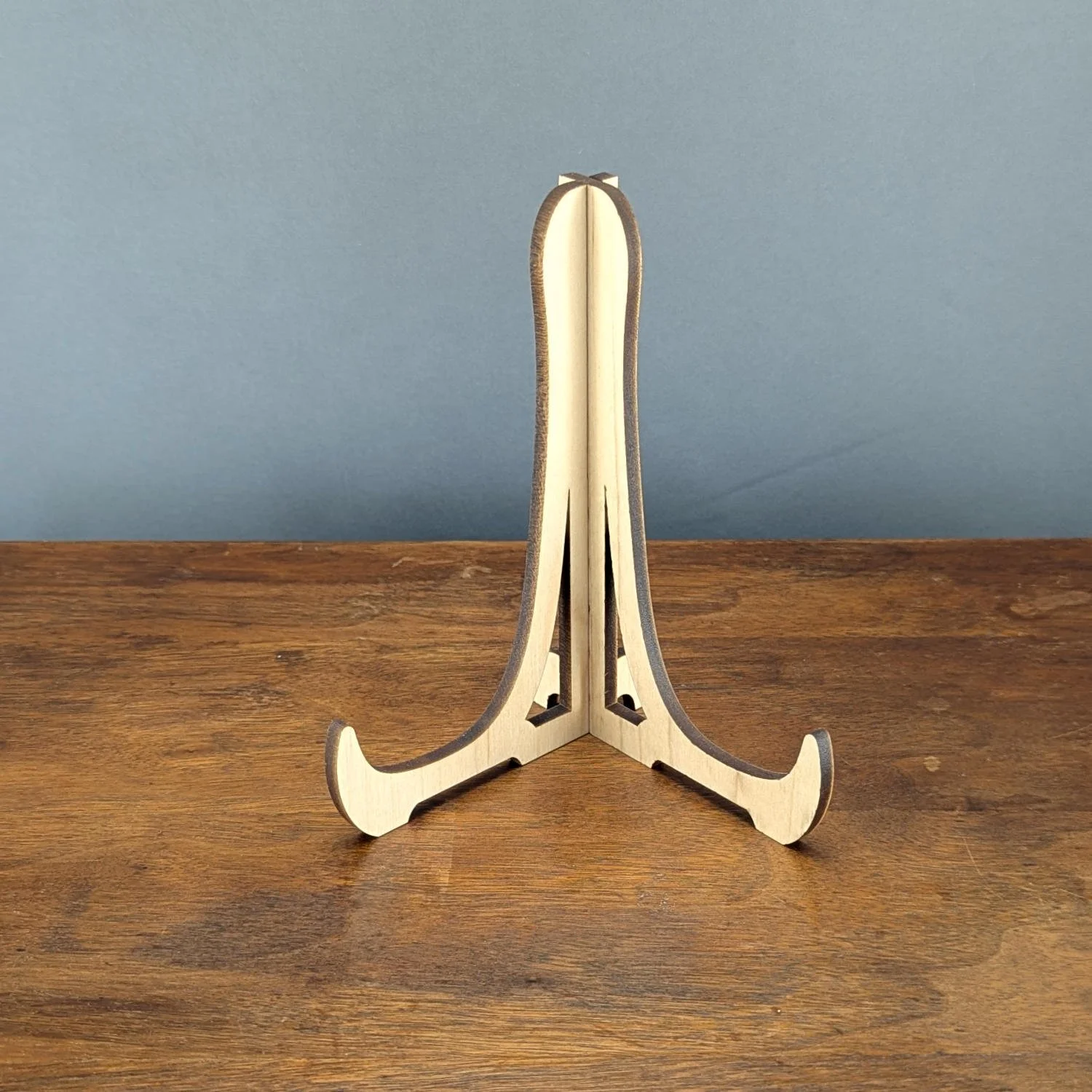 Solid maple cutting board stand assembled on wooden surface