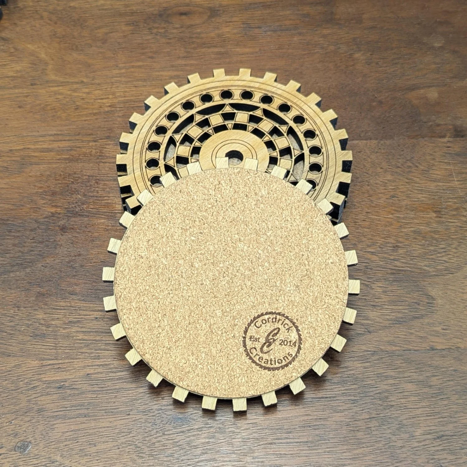 Back of The Engineer wooden gear coaster showing cork backing with Cordrick Creations logo.