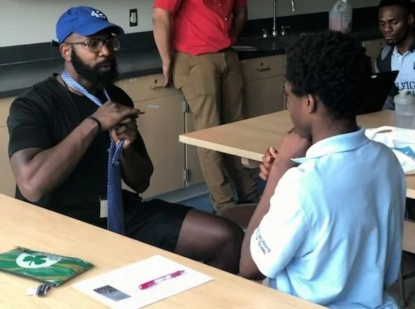 Young Man with a Plan - Adult male helps teen to tie a tie.