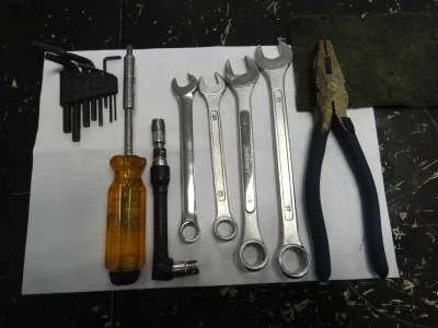 To begin with, here are all the tools needed for the job. From left to right, a 2.5mm allen key, a small diameter phillips head screwdriver, 8mm (ground down) socket spanner, 11mm, 12mm, 15mm and 17mm spanners, pliers and a scotchbrite pad.