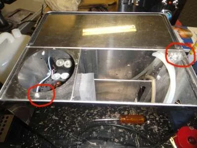 We now unscrew the two&nbsp;small phillips head screws holding the top on, and pull off the filter on the water inlet pipe.