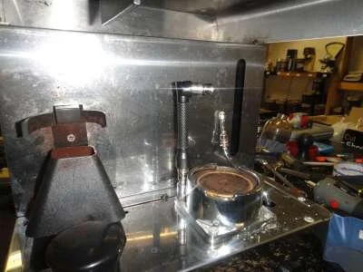 At this stage we turn the machine upside down, and using our trusty ground down 8mm socket spanner, undo the 4 group nuts and remove the group.