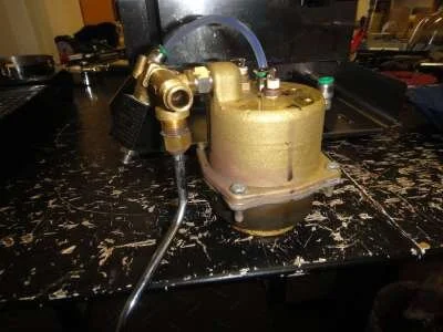 Now the whole boiler and steam assembly can be removed simply by lifting it up. Some manoeuvering of the steam wand may be necessary. Invert the boiler to drain it.