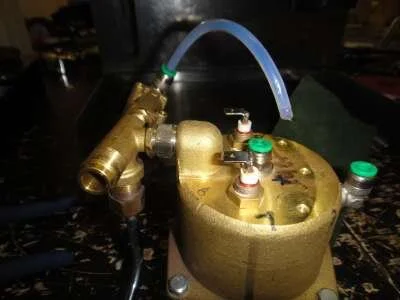 The boiler disassembly process can now begin. First, the teflon pipe from the top fitting can be removed with pliers and scotchbrite.