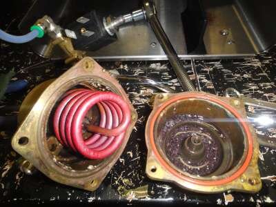 Unscrew the 4 x 8mm boiler bolts and seperate the halves. In this case we see a well cooked element (the colour gives the clue) and all the bits of burned off copper in the boiler base.