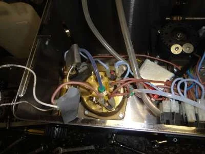 Put&nbsp;the boiler back in the machine and begin reconnecting, starting with the solenoid valve hose. Begin electrical reconnection with the reset thermostat at back. Be careful not to&nbsp;overtighten the soft brass thermostats.&nbsp;Don't forget to reconnect the earth and solenoid wires. Replace steam valve shaft and nut. Cover element connections with insulating tape before leak testing.
