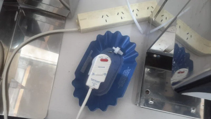 First thing we do is add a water tank and a drip tray, then we plug the machine in and test it using a power board with its own earth leakage circuit breaker, so if there's an electrical fault it doesn't take out the whole place.