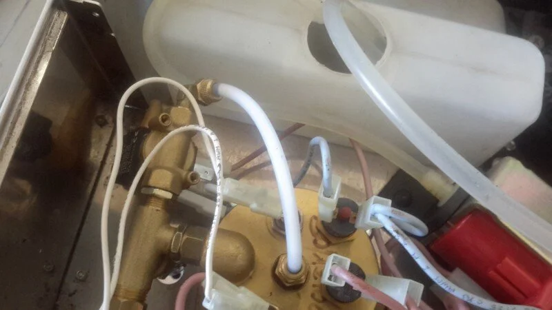 My original diagnosis via email was a tripped over-temperature thermostat, so we took off the top and inspected it. Sure enough, as soon as we pushed the red button in it clicked, and the machine functioned normally except for squirting water everywhere from the group.   Total repair time, 5 minutes, labour cost: $11.00 including GST.