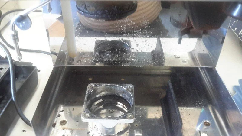 So we turned off the power, unplugged the machine and dropped the group collar.   That band of black inside the collar is an eleven year accumulation of coffee crud.   Time to turn the machine upside down, remove the showerscreen and inspect the group