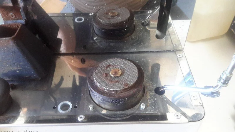 Upside down and the solidified group gasket and filthy showerscreen are obvious.   First step is to remove the water distributor nut