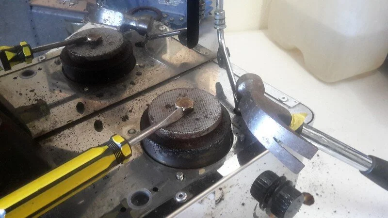 Even with a correctly sized spanner (14mm) there is no way to budge the water distributor nut, so we use a short screwdriver and a hammer to "chisel" it anticlockwise. Brute force over finesse, but it works!