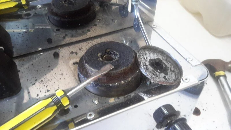 First we took off the ancient, rock solid group gasket, then after gently prying the showerscreen off, we found a 1-2 mm thick solid buildup of 11 year old crud stuck to the group.   The showerscreen itself was totally blocked, which explained the squirting water.