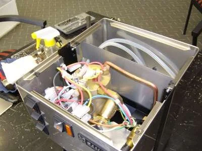 UNPLUG THE MACHINE!    Remove the water tank and unscrew the 4 screws. Remove the top pane