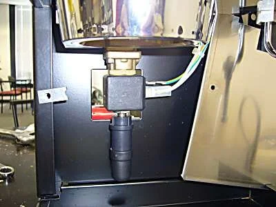 Undo the two screws and slide the front panel out to the right.   This gives you complete access to the solenoid valve assembly.