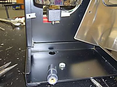 Undo the spout, then the coil retaining nut.