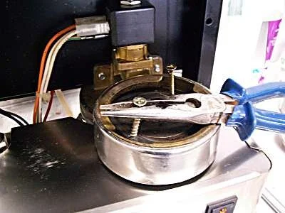 The quickest way to remove old group gaskets from any machine is to screw a couple of self tapping woodscrews into them and pull the screws out with pliers.   Even if the gasket comes out in chunks it gives you a chance to chisel out the rest.