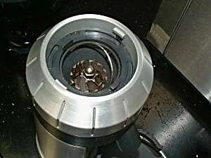 Looking down into the adjustment collar at the top burr carrier and its little wire handle.