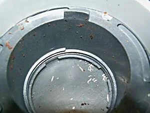 Looking down into the adjustment collar, displaying the plastic threads. The steep thread pitch is obvious.