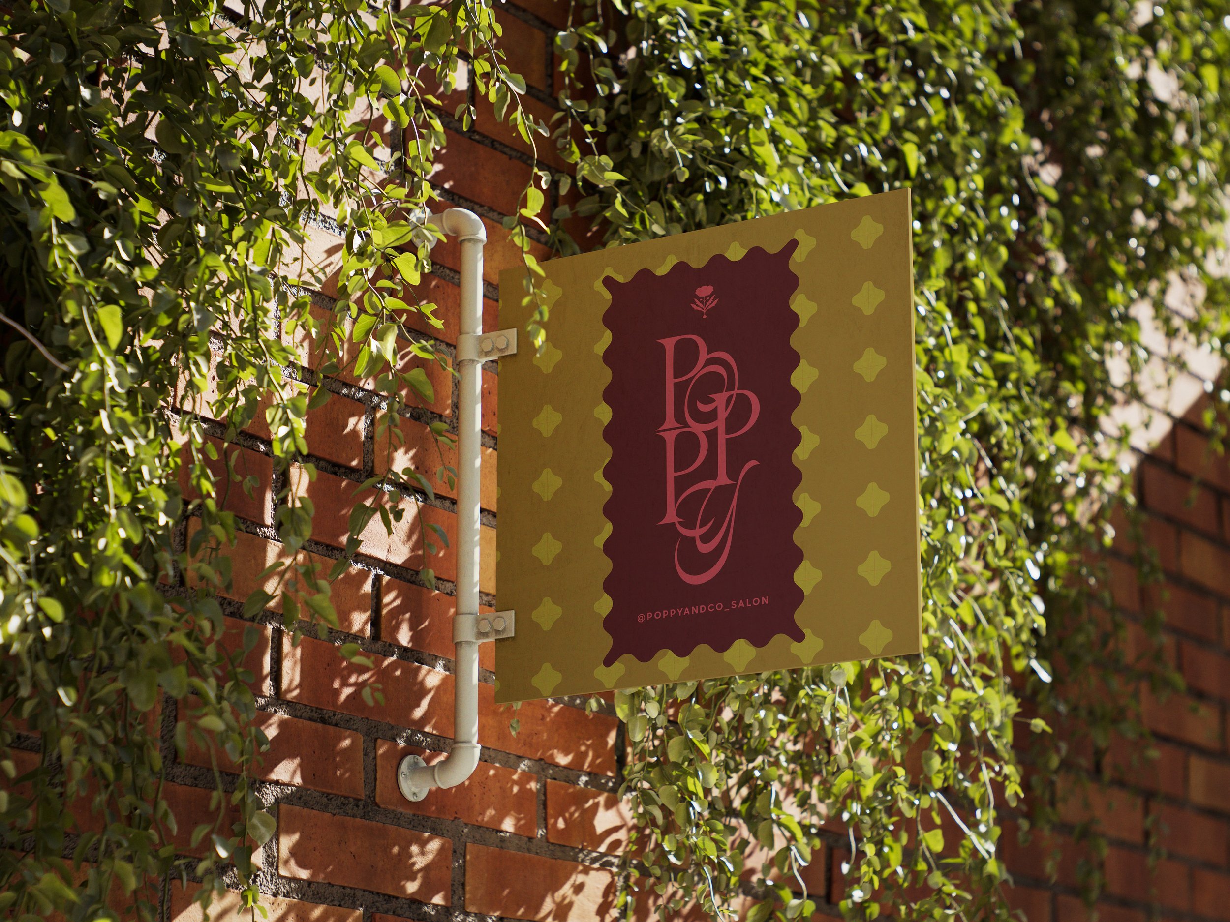 A decorative sign with the text 'POPPY' on a brick wall, surrounded by green ivy plants.