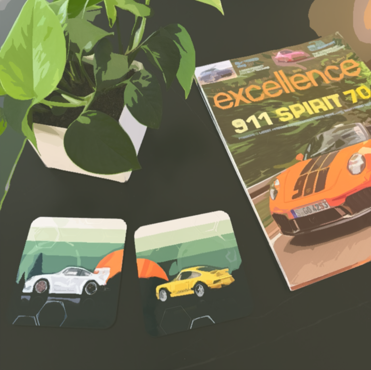 Top view of a potted plant, a magazine titled 'The Excellence 911 Spirit 70', and two small car models, one white and one yellow, on a black surface.