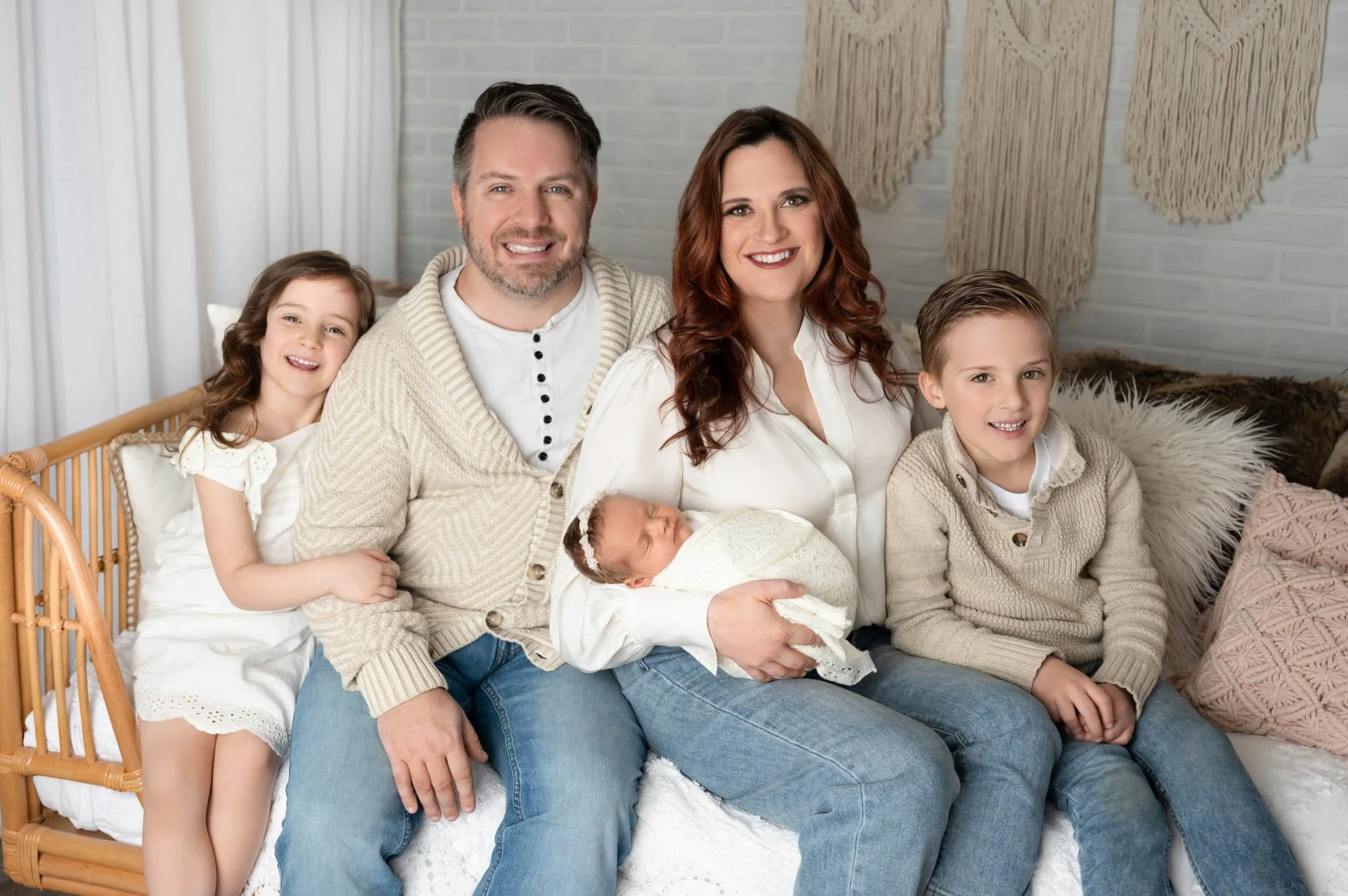 family of five pose for newborn family photoshoot