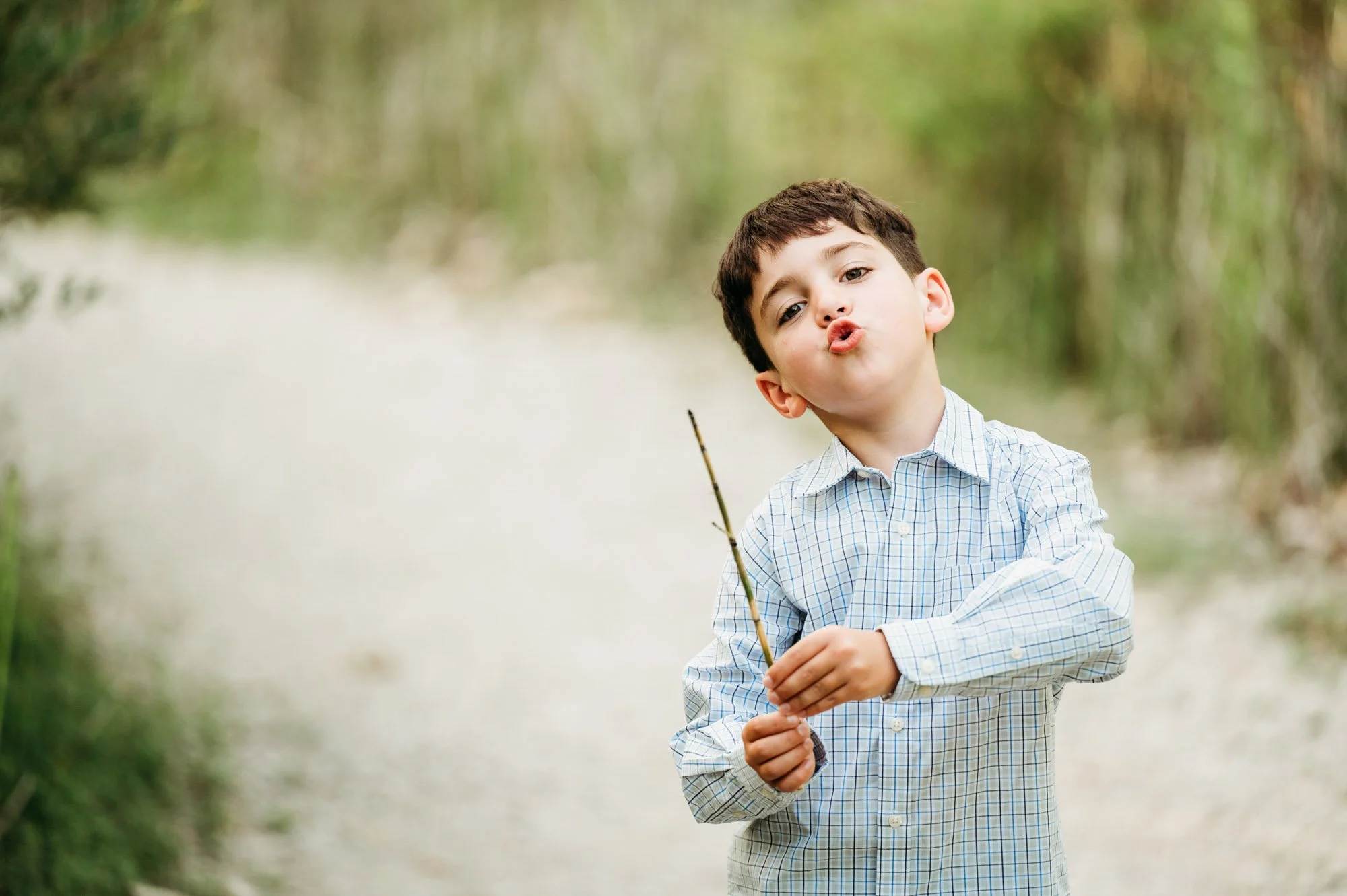 boy having fun with his stick during carmel, IN maternity photoshoot