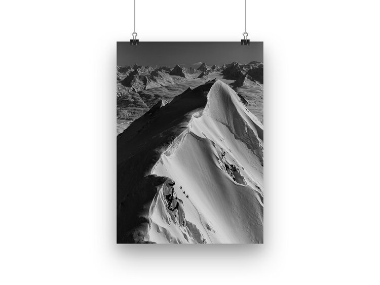 Black and white photo of a snowy mountain ridge