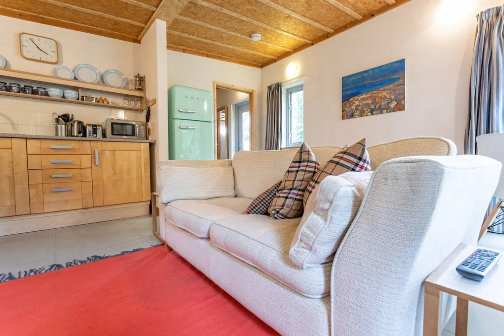 Sofa living room and kitchen area in Y Caban, Foxhill, St Dogmaels  Pembrokeshire Holiday Co