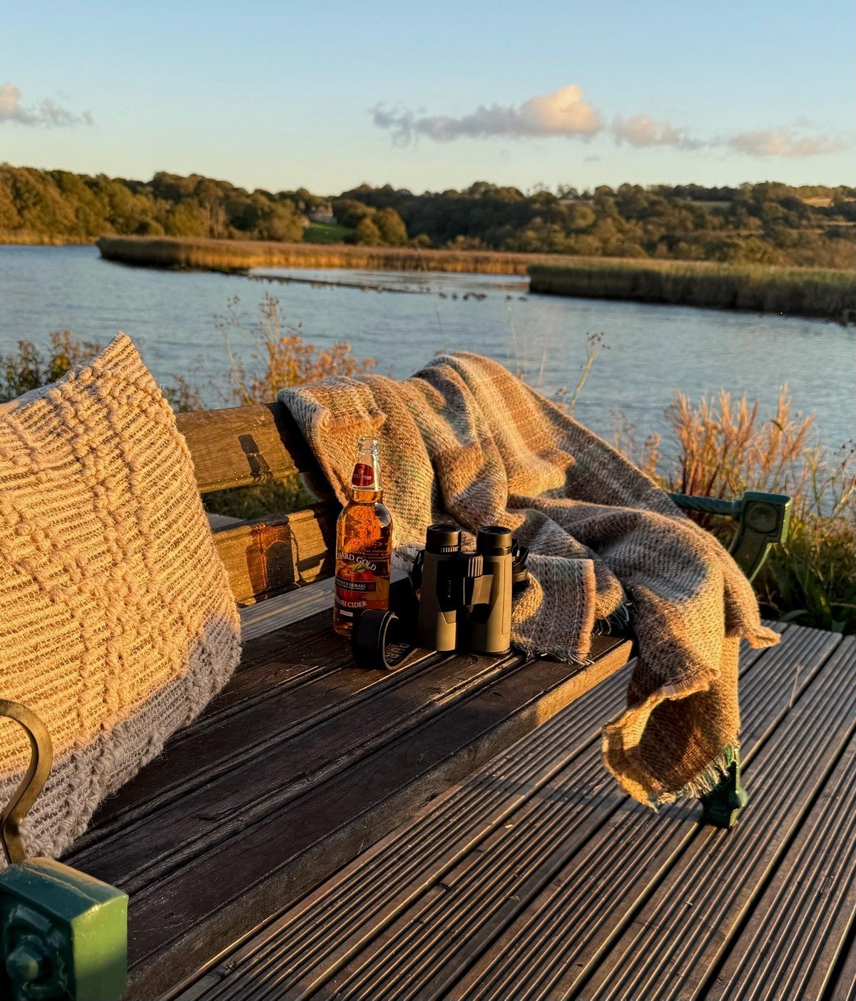 Seren Loft riverside seating and decking area with blankets and river Teifi behind - Fronteifi Cardigan - Pembrokeshire Holiday Co