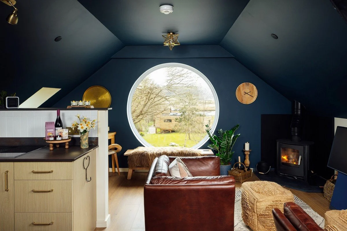 Seren Loft Fronteifi living room with large circle window - Pembrokeshire Holiday Co