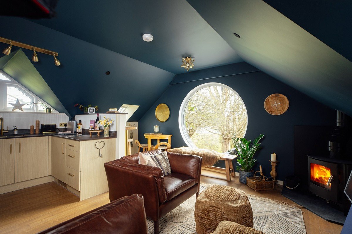 Seren Loft Fronteifi living room with large circle window - Pembrokeshire Holiday Co