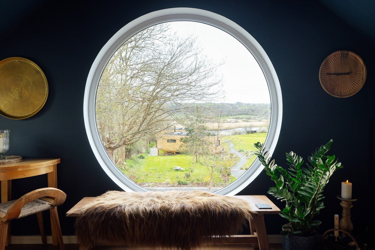 Seren Loft Fronteifi living room with large circle window - Pembrokeshire Holiday Co