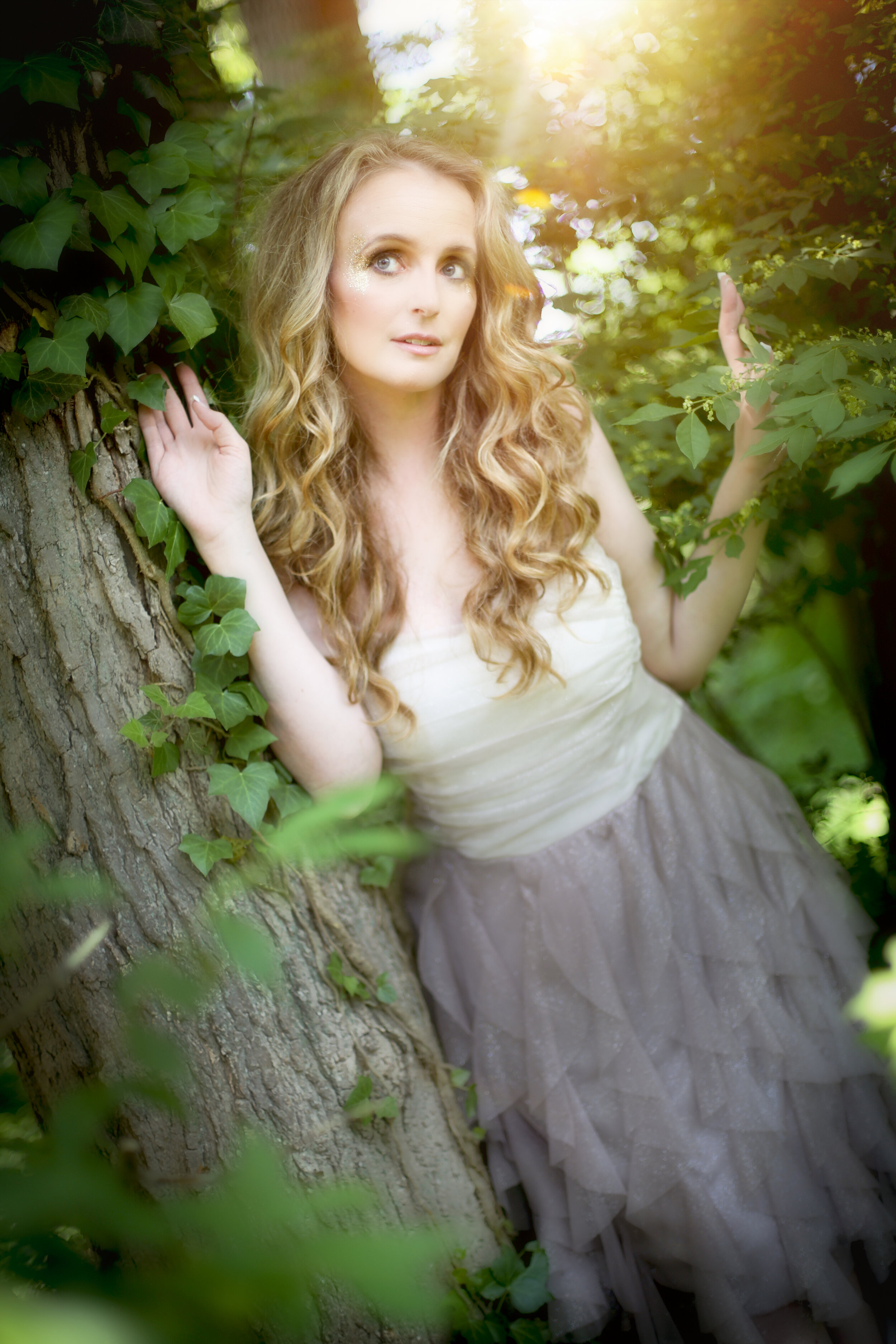 boston boudoir photographer Stephanie Olsen garden goddess sexy woman in lingerie gown in forest garden ivy sun flare