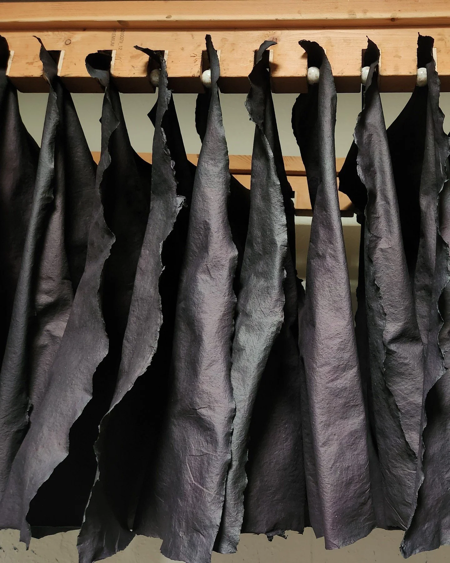 Many of our designs rely on layers and layers of natural dyes built up over time.

These flax papers have been dipped in indigo four times, followed by several applications of walnut dye. Between each layer of dye, the paper must dry fully. The walnu