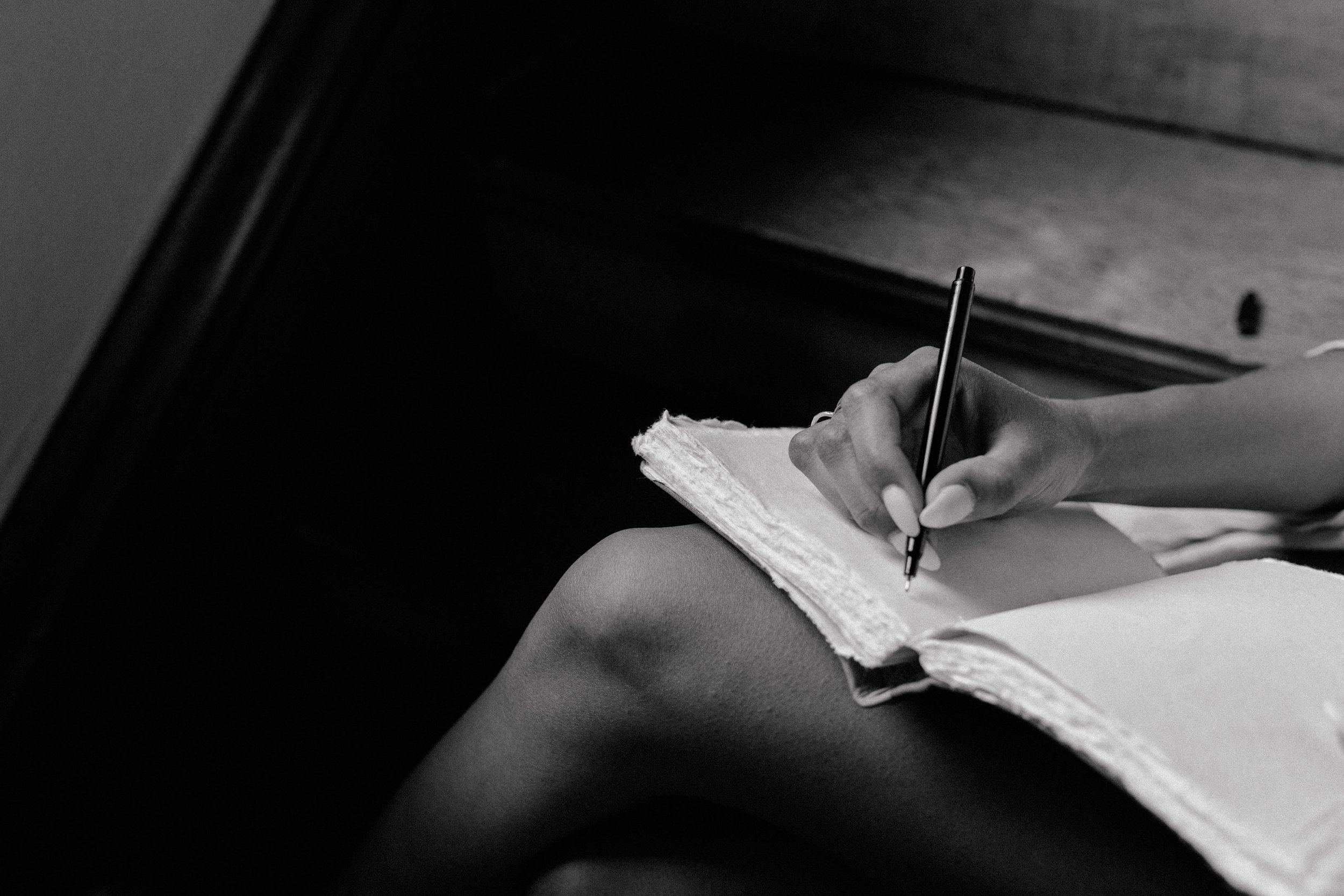 Woman with a blank notebook and a pen Dakota Design Company best templates for interior designers