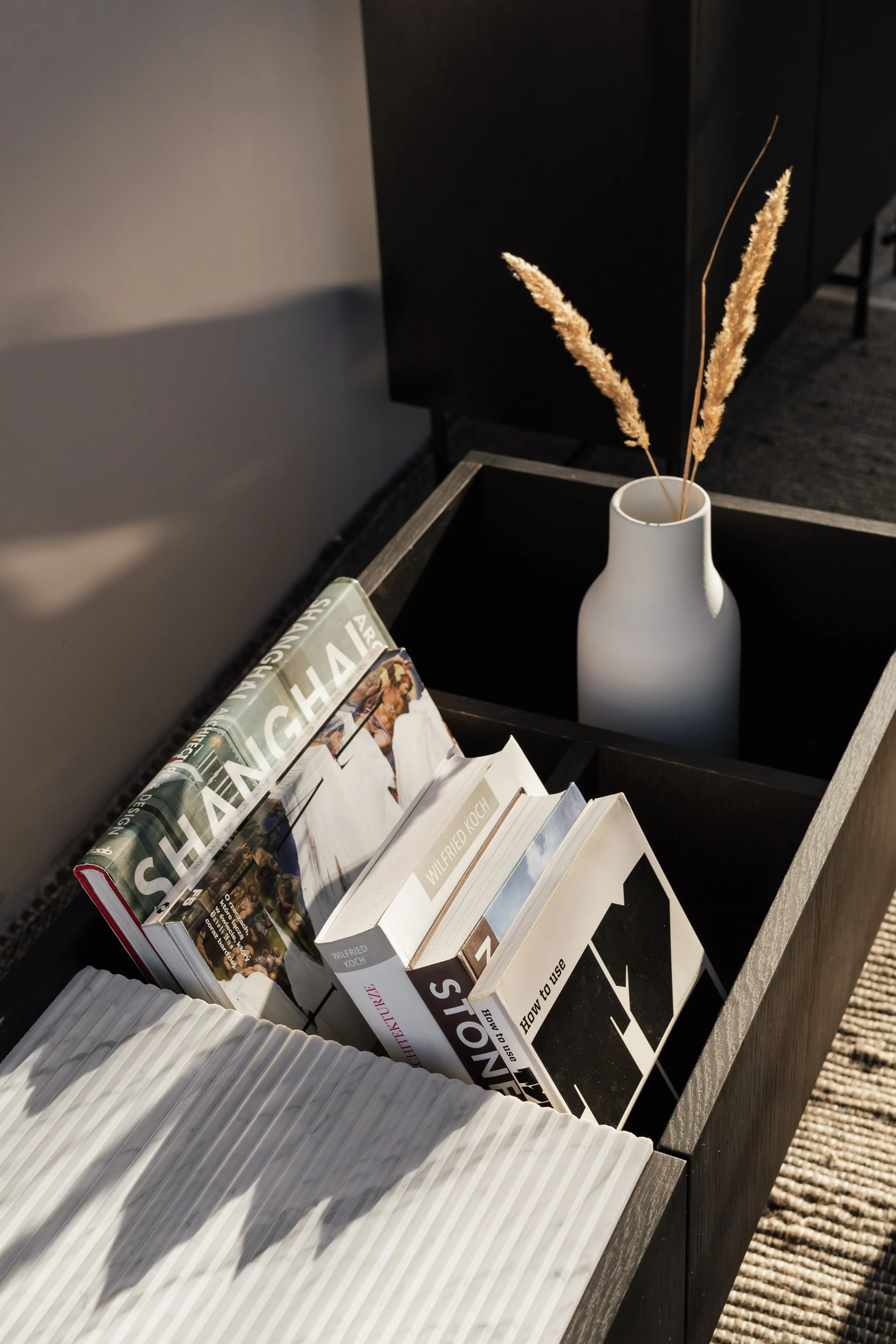 Coffee table books in a wooden container
