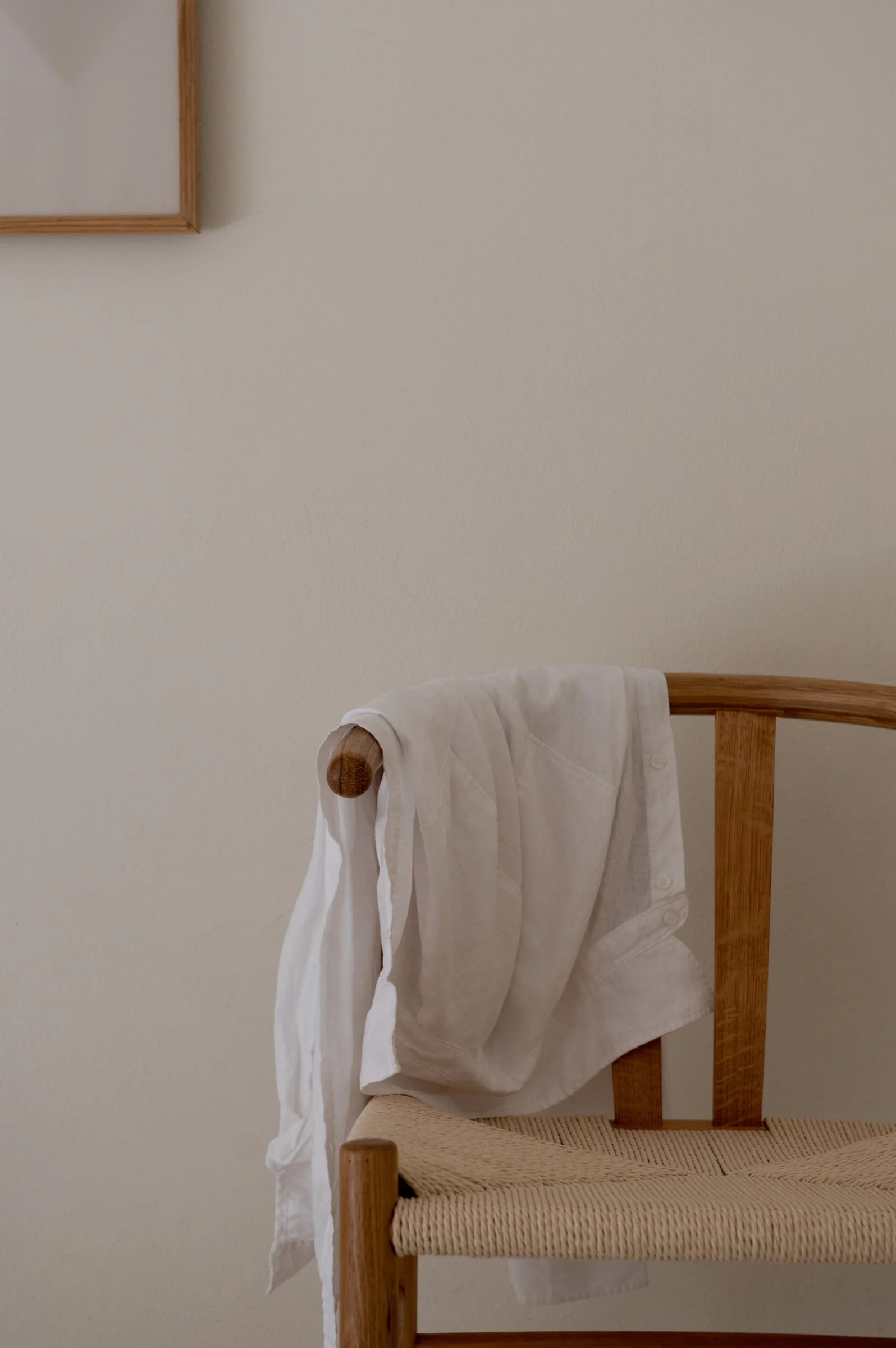 Image of a chair with a shirt hanging over the side