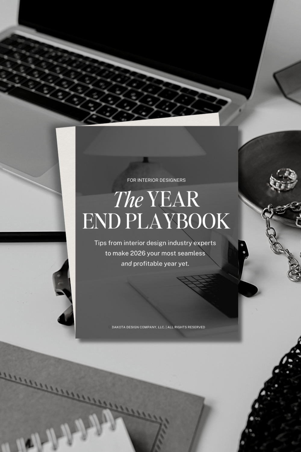 Desktop with PDF that says Year End Playbook for Interior Designers by Dakota Design Company.png