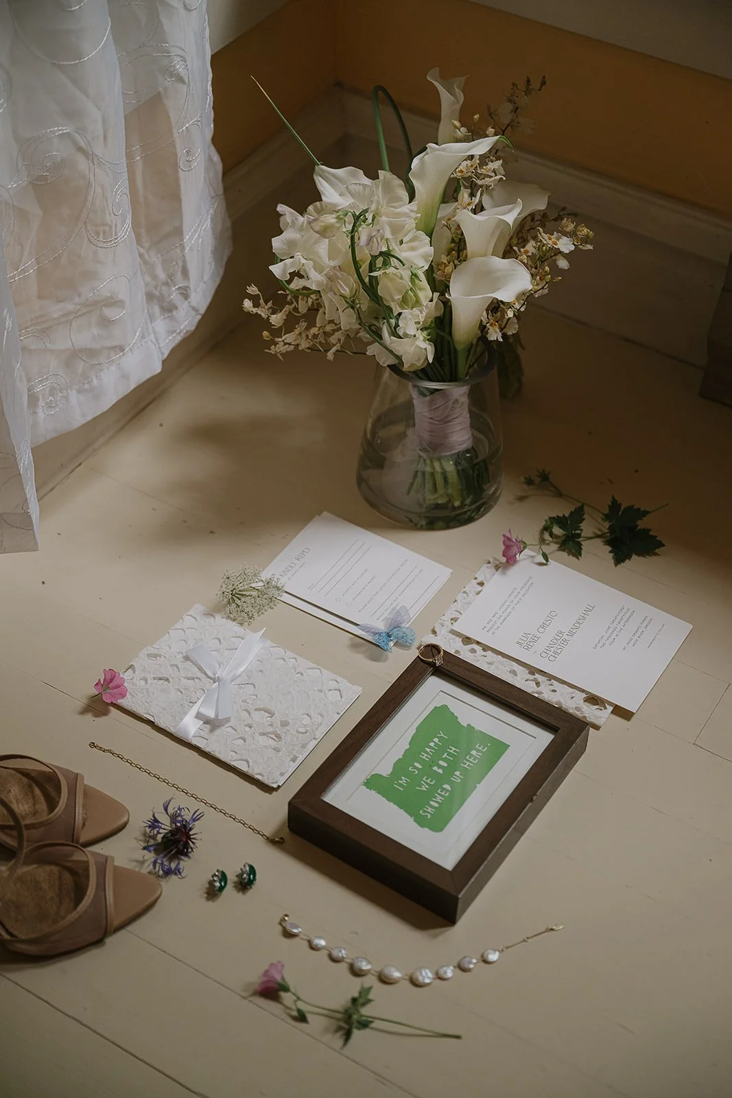 An aerial shot of a whimsical garden inspired flatlay including a modern white bridal bouquet