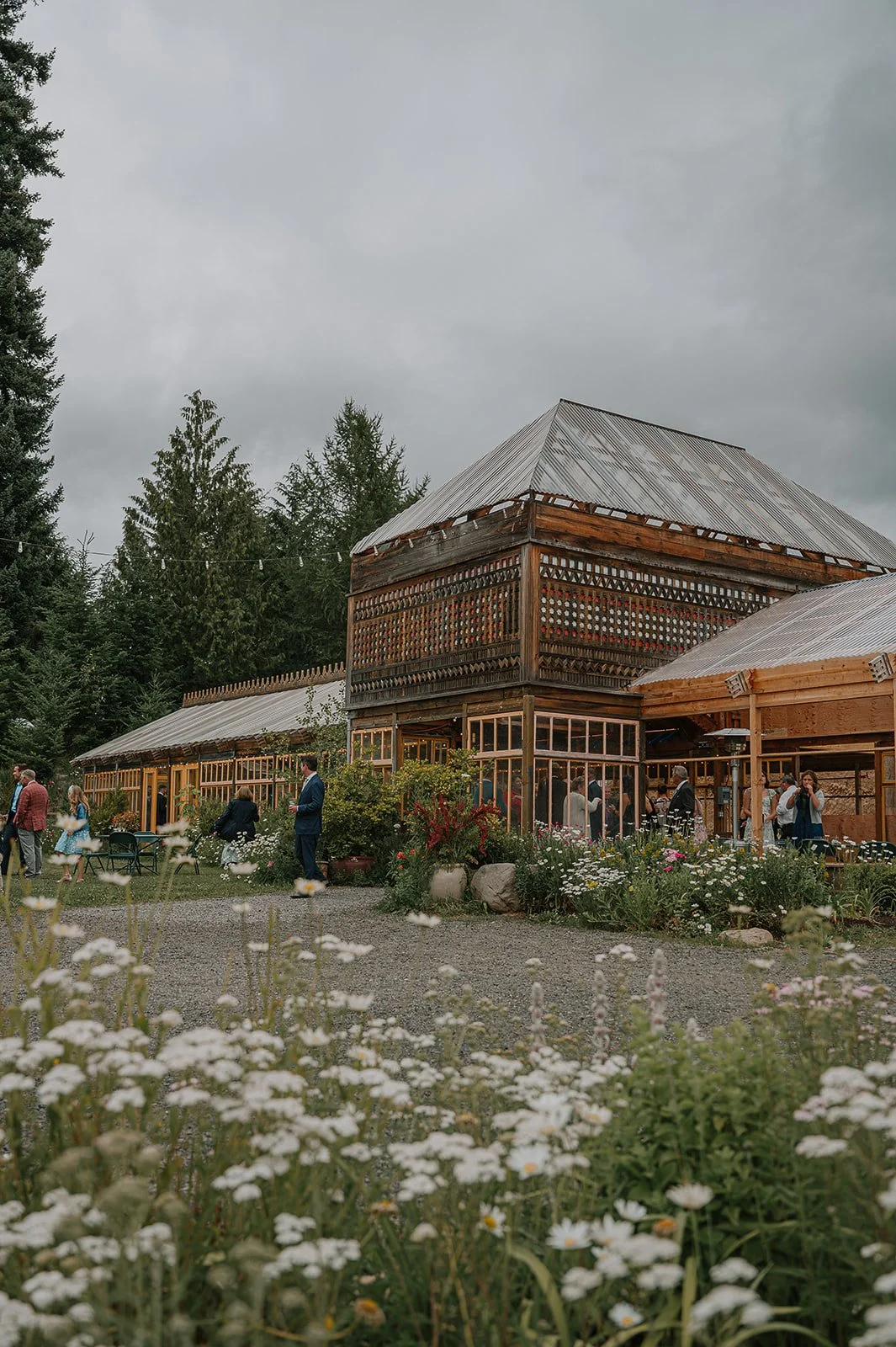A wide shot of the iconic Greenhouse at Mt. Hood Organic Farms. Surrounded by carefully curated lush landscape.