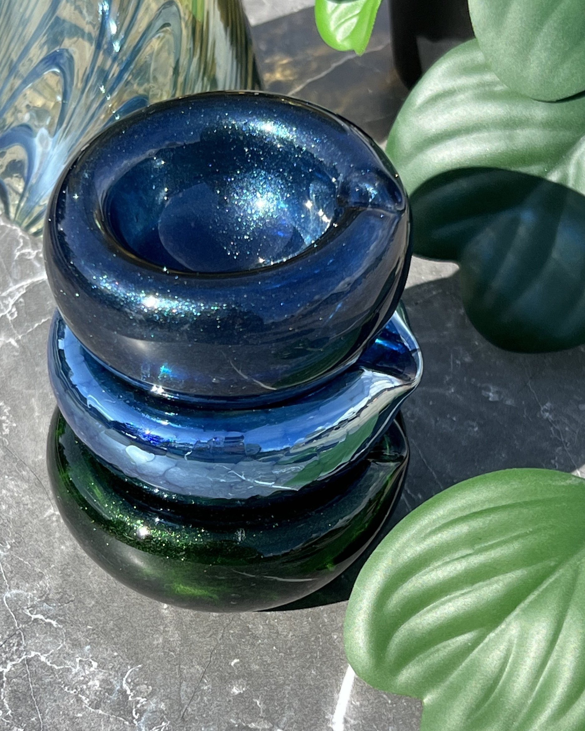 three blown glass ashtrays stacked one on top of the other